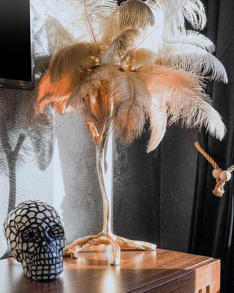 Ostrich feather palm lamp and black mosaic skull decor in the Calypso Suite at Gaspar's Luxury Estate, Tampa.