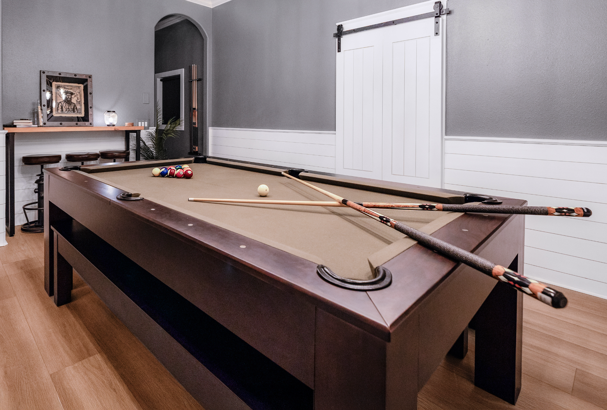 Luxury South Tampa Airbnb game room featuring a convertible billiards table and pirate-inspired decor.