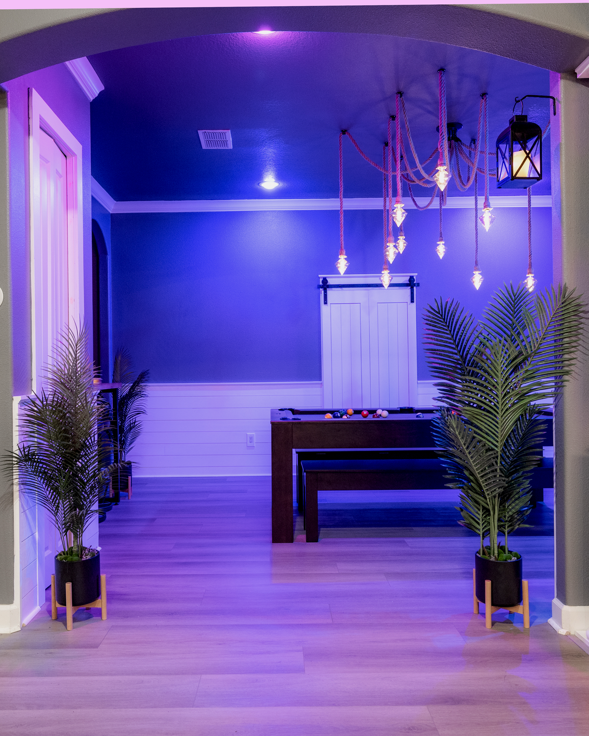Color-changing LIFX smart recessed lighting in the formal dining and pool hall at Gaspar’s Luxury Estate in South Tampa