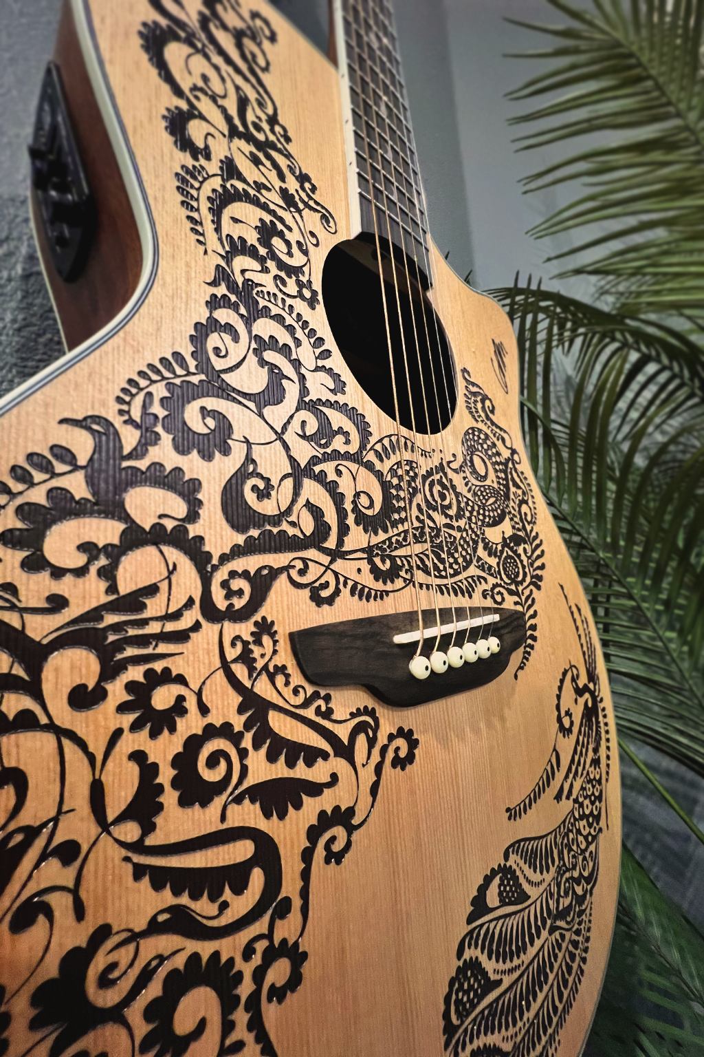 Acoustic guitar with intricate medieval Spanish design available for guest use at Gaspar’s Luxury Estate in South Tampa.