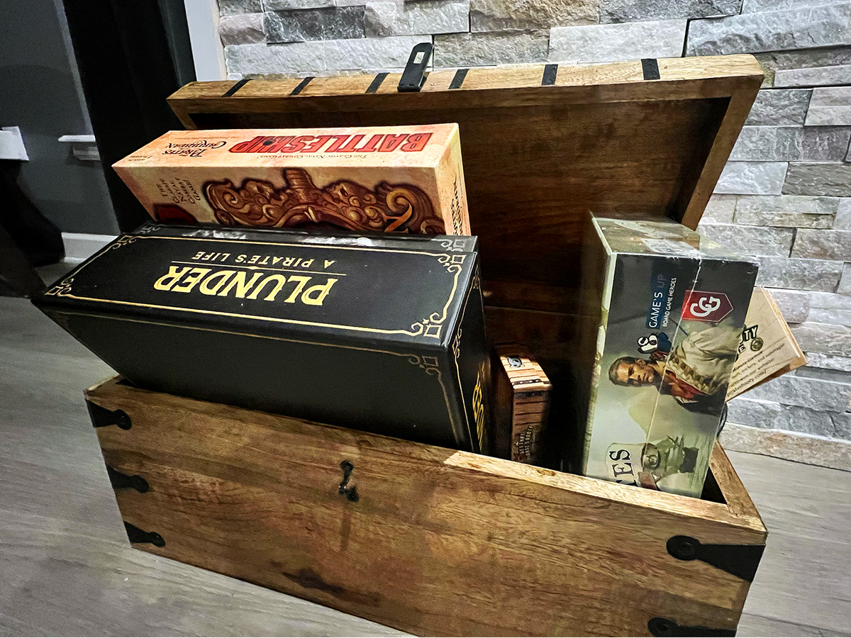 Pirate themed board games stored in a pirate-style chest at Gaspar’s Luxury Estate in South Tampa.