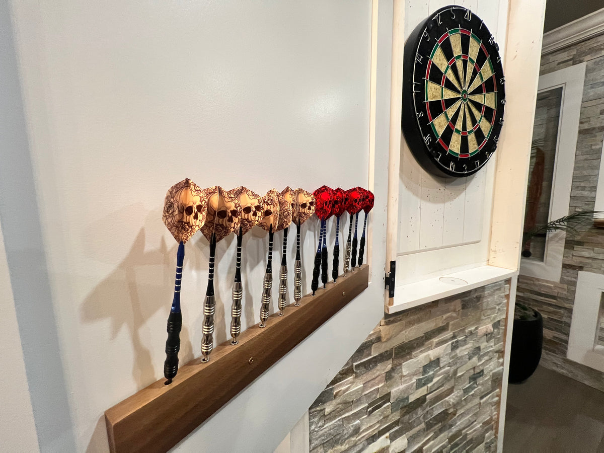 Pirate-themed darts mounted beside the dartboard in one of the game areas at Gaspar’s Luxury Estate in South Tampa.