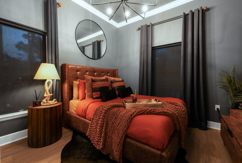 Havana Hideout suite at Gaspar's Estate Tampa with a tufted leather bed, rust-colored linens, and nautical rope lamp.