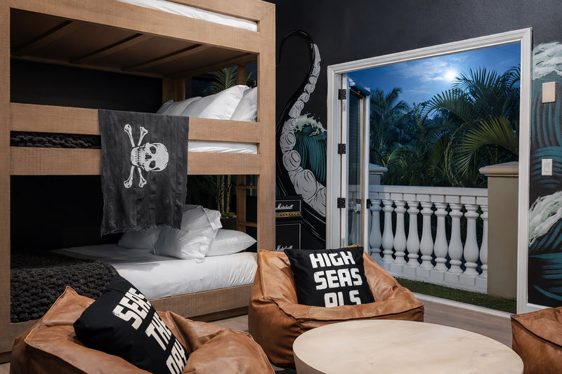 Kraken Cove at Gaspar's Estate Tampa with custom RH bunk beds, pirate mural, leather bean bags, and private balcony.