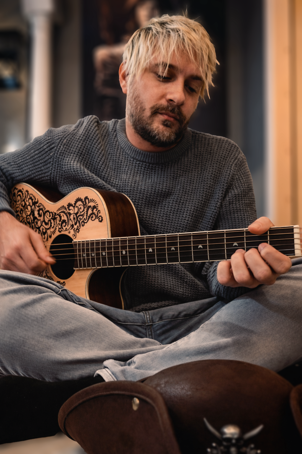 Guest playing acoustic guitar during a creative retreat at Gaspar’s Luxury Estate in South Tampa.